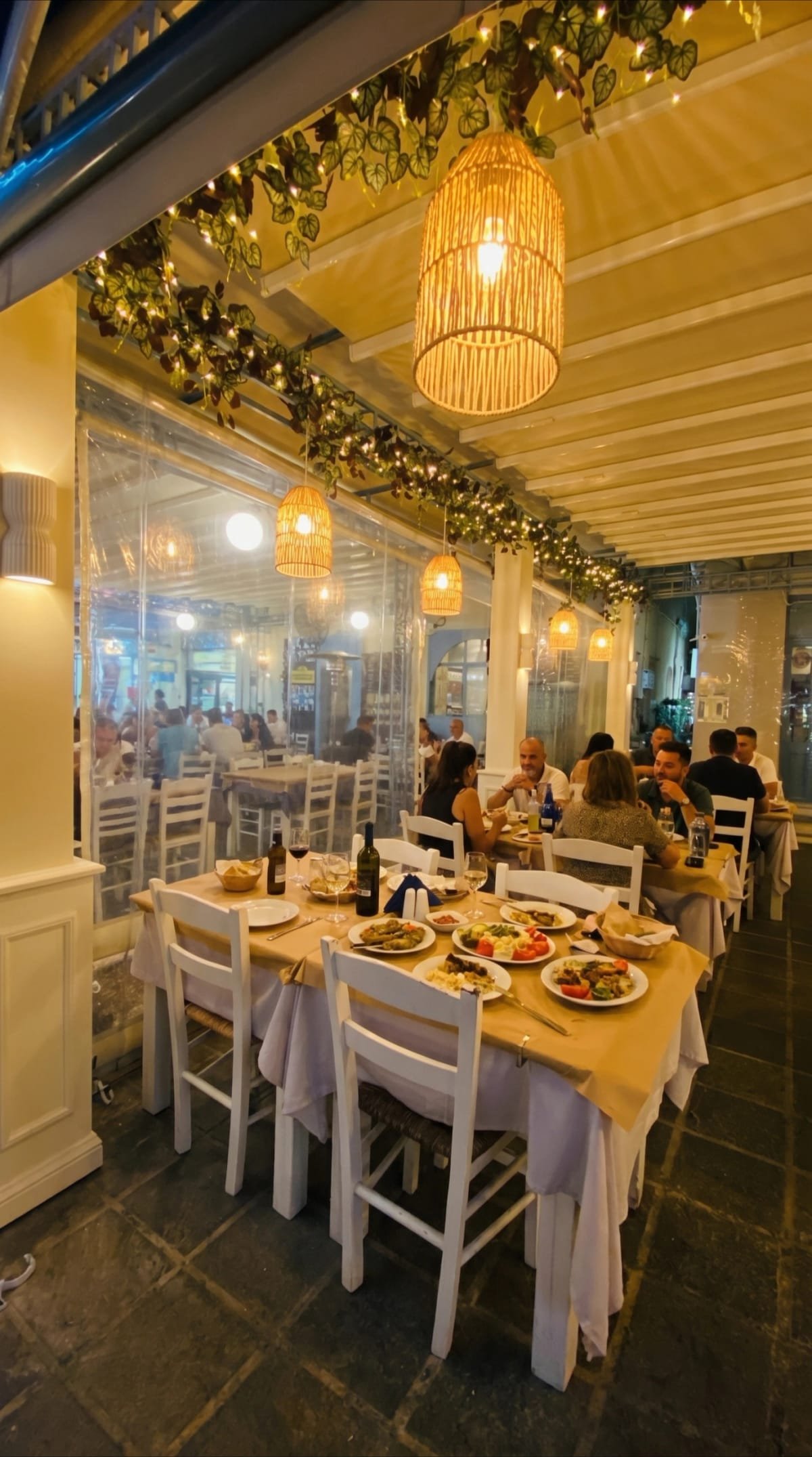 Covered terrace dinner at Sti Rota with warm pendant lights.