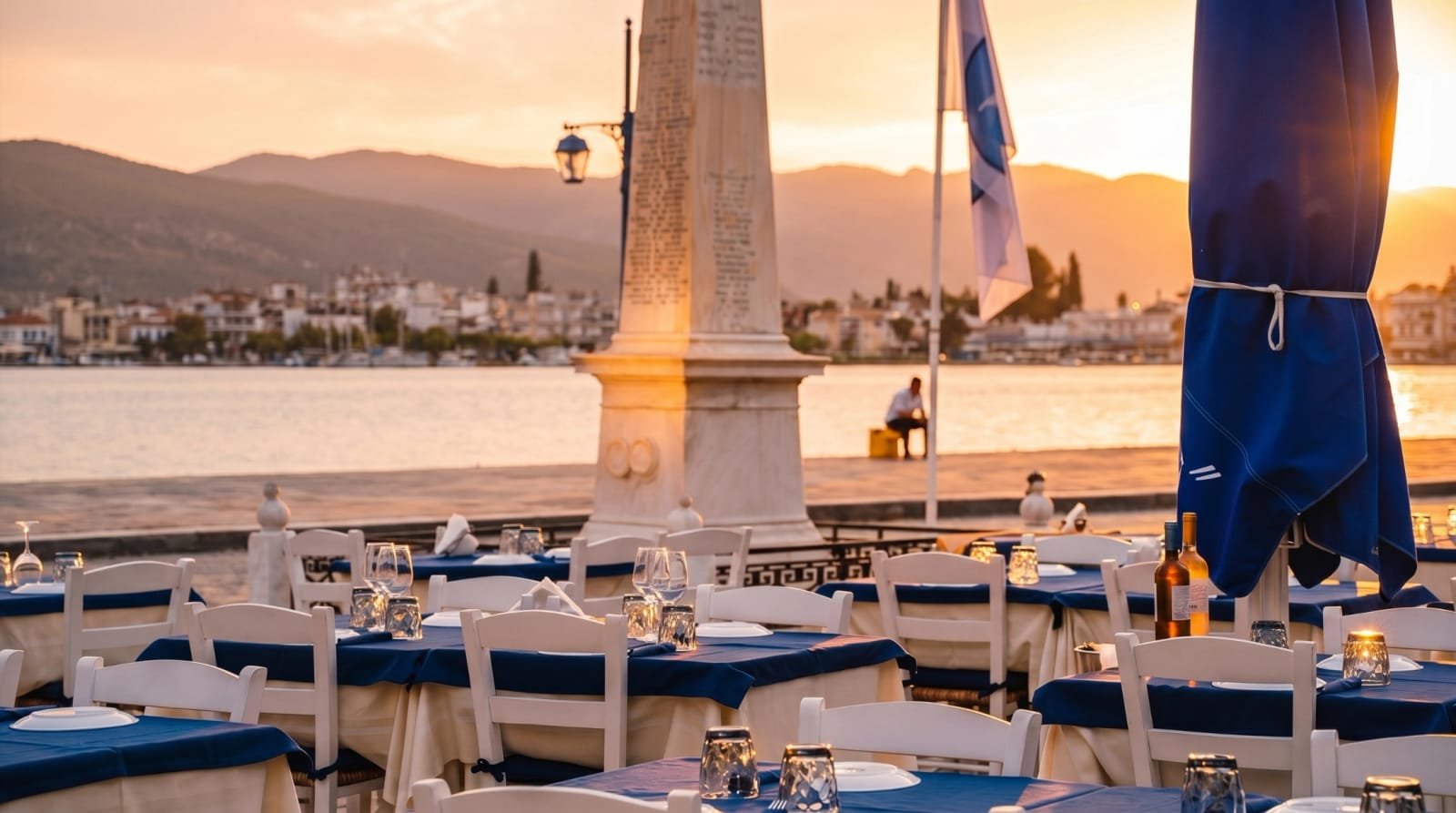 Waterfront table scene at sunset at Sti Rota, a Greek taverna in Poros.
